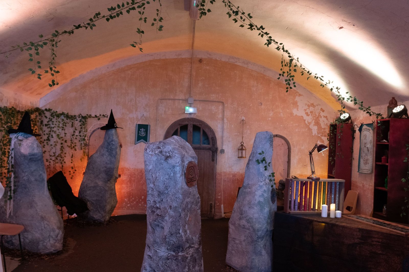 Salle voûtée immersive aux statues de sorciers